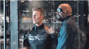  ?? MARVEL PHOTOS ?? Cap (Chris Evans) and Nick Fury (Samuel L. Jackson) are at the center of a big ol’ conspiracy in “Captain America: The Winter Soldier.”