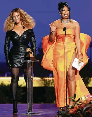  ?? Kevin Winter / Getty Images for The Recording Academy ?? Beyoncé, left, in custom Schiaparel­li and Megan Thee Stallion in Dolce & Gabbana