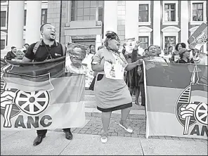  ?? AP/MARK WESSELS ?? African National Congress supporters celebrated Tuesday outside parliament in Cape Town, South Africa, after President Jacob Zuma survived a no-confidence vote.