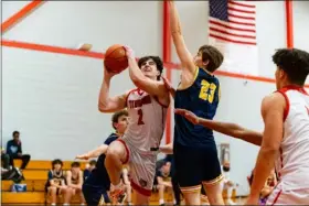  ?? JAMES THOMAS PHOTO ?? Tyngsboro’s Joey Nicosia, left, goes into the paint to face the tough defense of Littleton’s Carter Dionne during Tuesday’s boys basketball clash. Host Tyngsboro won, 61-48.
