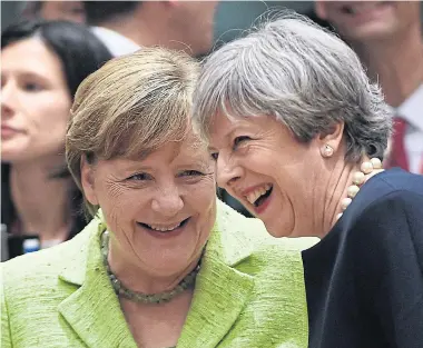  ?? AFP ?? British Prime Minister Theresa May, right, laughs with German Chancellor Angela Merkel at the European Council in Brussels on Thursday.