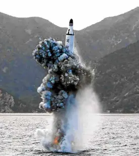  ?? AFP ?? AMISSILE is launched from a submarine at an undisclose­d location in North Korea, in this photo provided by North Korea’s official news agency. Kim Jong-un hails the missile test as an “eye-opening success,” declaring that Pyongyang now has the ability...
