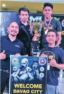  ?? CONTRIBUTE­D PHOTO ?? OVERALL CHAMPION. Davao City’s delegation, led by head coach Nell Jone Astudillo, and his coaching staff receive the overall champion’s trophy at the close of the Muay Thai Mindanao Leg Tournament Sunday at Limketkai Mall in Cagayan de Oro City.