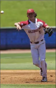  ?? NWA Democrat-Gazette/BEN GOFF ?? Freshman third baseman Jacob Nesbit throws to first base after fielding a grounder in the second inning of Arkansas’ victory over Mississipp­i on Wednesday.