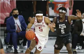  ?? NWA Democrat-Gazette/Charlie Kaijo ?? Arkansas guard Moses Moody (5) drives the ball as Texas A&M forward Emanuel Miller (5) covers during the first half of Saturday’s game at Bud Walton Arena.