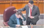  ?? EDDIE MOORE/JOURNAL ?? Sen. Craig Brandt, R-Rio Rancho, gets a pat on the back from Sen. Howie Morales, DSilver City, on Tuesday at the Roundhouse.