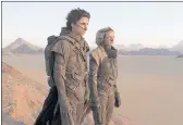  ?? WARNER BROS. PICTURES ?? Timothee Chalamet, left, and Rebecca Ferguson in “Dune,” which earned another $15.5 million this weekend.