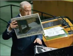  ?? CRAIG RUTTLE — THE ASSOCIATED PRESS ?? Israeli Prime Minister Benjamin Netanyahu prepares to display a photograph as he addresses the 73rd session of the United Nations General Assembly, at U.N. headquarte­rs, Thursday.