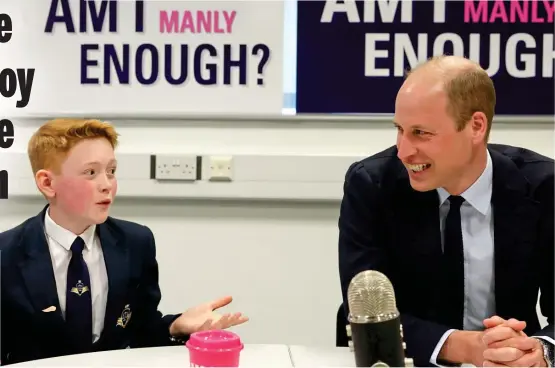  ?? ?? Lighter moment: The Prince of Wales beams as he chats with Freddie Hadley at the 12-year-old’s school in the West Midlands