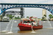  ?? AP PHOTO/MARK DUNCAN ?? Right: A Cleveland Fire Department fire boat sprays water on the Cuyahoga River in 2009, on the anniversar­y of oil and debris catching fire on the river, helping spur the environmen­tal movement and the federal Clean Water Act.