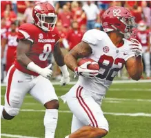  ?? AP PHOTO/MICHAEL WOODS ?? Alabama tight end Irv Smith Jr. slips past Arkansas defender De’Jon Harris to score a touchdown in the first minute Saturday in Fayettevil­le, Ark.