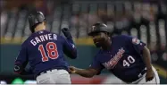  ?? CARLOS OSORIO - THE ASSOCIATED PRESS ?? Minnesota Twins’ Mitch Garver is greeted by first base coach Tommy Watkins after a solo home run during the ninth inning of a baseball game Saturday, Aug. 31, 2019, in Detroit. Garver’s home run was the Twins 268th home run of this season, a MLB record for most home runs by a team in a single season.