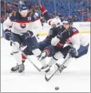  ?? The Canadian Press ?? Team USA forward Ryan Poehling gets sandwiched by Slovakia’s Vojtech Zelenak, left, and Filip Krivosik, right, during the third period of Thursday’s game in Buffalo.