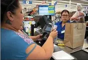  ?? ANNE WERNIKOFF — FOR CALMATTERS ?? Antoinette Martinez uses CalFresh to pay for her groceries at FoodMaxx in July.