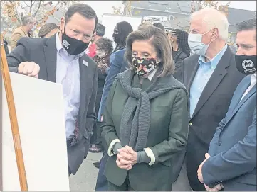  ?? PHOTOS BY ARIEL CARMONA — LAKE COUNTY PUBLISHING ?? Speaker of the House Nancy Pelosi (D-San Francisco), flanked by local and state legislator­s, surveys a poster board showing the recovery of the Coffey Park area prior to a press conference on infrastruc­ture and wildfire resiliency held Saturday in Santa Rosa