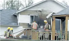  ?? HARRY ROSSETTANI/SPECIAL TO POSTMEDIA NEWS ?? Firefighte­rs assess the damage after a fire at a home on Albany Street in Fort Erie Monday.