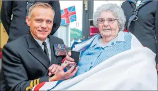  ??  ?? AT LONG LAST: Commander Keith presents Kathleen Blower with her medal