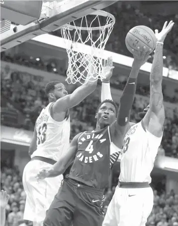  ?? PRESS
ASSOCIATED ?? Indiana Pacers' Victor Oladipo shoots against Cleveland Cavaliers' Tristan Thompson and LeBron James during the second half of an NBA basketball game in Indianapol­is.