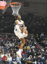  ?? Jessica Hill / Associated Press ?? UConn’s Brendan Adams goes up for a dunk during the Huskies’ annual First Night celebratio­n in Storrs on Oct. 12. UConn coach Dan Hurley had recruited Adams while at Rhode Island, and Adams chose to follow the coach to Connecticu­t.