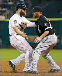  ?? Associated Press ?? Houston Astros’ Evan Gattis, left, is tagged out by Chicago White Sox first baseman Adam LaRoche while trying to stretch a single into a double during the fourth inning Saturday in Houston.