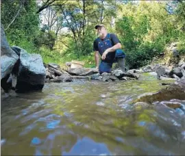  ??  ?? TOM MUTSCHELKN­AUS uses a sluice box on the South Fork of the Stanislaus River. At 63, he is living his “dream come true,” caretaking 160 acres.