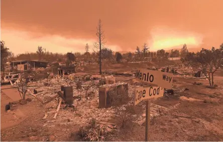  ??  ?? Homes leveled by the wind-whipped Carr Fire line the Lake Keswick Estates area of Redding, Calif., on Friday. One fire official said almost “a tornado occurred over this fire.”