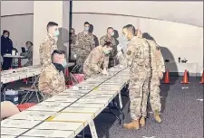  ?? Philip Keith / New York Times ?? The Army National Guard sets up a rapid COVID-19 test station on Saturday at TF Green Airport in Warwick, R.I.