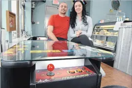  ?? STEVE HENSCHEL NIAGARA THIS WEEK ?? Frank Fiorilli and Alexis Pancer are serving up more than subs at Mr. Panini on King Street in Welland, as the newly-opened eatery aims to bring late-night food, and a classic '80s arcade atmosphere complete with table top games, priced at a quarter, to the city.