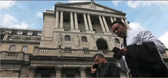  ?? — AFP ?? Giving support: Pedestrian­s walks past the Bank of England building in London. The BOE interventi­on last Wednesday relieved the immediate pressures and has allowed markets to resume functionin­g, albeit with liquidity still strained.