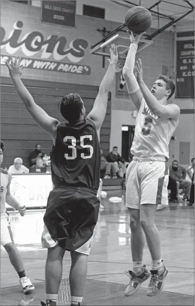  ?? DANA JENSEN/THE DAY ?? St. Bernard’s Max Lee (5) goes up for a shot against Putnam’s Mike DiColella (35) during Thursday’s boys’ basketball game at Montville. Lee scored 15 points as St. Bernard won 63-36 in the season opener for both teams.