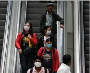  ?? REUTERS ?? Passengers wearing protective masks travel on an escalator at an airport terminal following an outbreak of the coronaviru­s disease (COVID-19), in New Delhi, on Saturday.