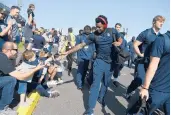  ??  ?? UConn football players greet fans as they enter Rentschler Field before Saturday’s game against Holy Cross.