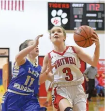  ?? STAFF PHOTO BY MATT HAMILTON ?? Whitwell’s Jamie Rollins drives to the hoop as Bledsoe County’s Cyla Swafford defends during Thursday night’s game at Whitwell.
