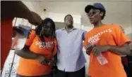  ?? DAVID J. PHILLIP - THE ASSOCIATED PRESS ?? George Dorsey, center, prays with Samaritan’s Purse volunteers Nikki Moore, left, and Samantha Roundtree, who are helping to rebuild his hurricane-damaged home in Houston.