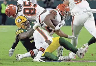  ?? GETTY IMAGES ?? Packers nose tackle Kenny Clark wraps up the Browns’ Nick Chubb on Saturday. Clark earned his second Pro Bowl nod last week.