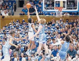  ?? JARED C. TILTON/GETTY ?? Duke’s Jeremy Roach (3) attempts a shot against North Carolina’s Brady Manek at Cameron Indoor Stadium on March 5 in Durham, North Carolina.