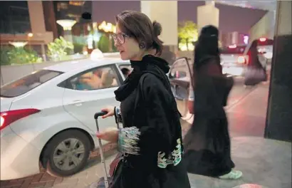  ?? Carolyn Cole Los Angeles Times ?? SOVEREIGN WEALTH funds are used to writing big checks — and Uber is so valuable now that few in Silicon Valley have the funds to buy a stake. Above, a woman waits for an Uber ride at a shopping mall in Riyadh, Saudi Arabia.