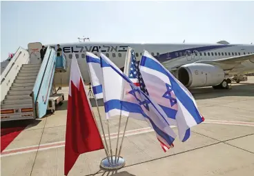  ?? (AFP) ?? The Bahraini, Israeli and US flags are placed in front of El Al plane ahead of the flight to Bahrain’s capital Manama for a formal launch of diplomatic relations, at Israel’s Ben Gurion Airport near Tel Aviv on Sunday