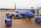  ?? THE COMMERCIAL APPEAL FILE ?? A Southwest airplane is loaded for travel at the Memphis Internatio­nal Airport on March 16, 2020.