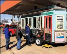  ?? Arkansas Democrat-Gazette/JENNIFER CHRISTMAN ?? Diners line up outside the Southern Salt Food Co. truck, parked at The Food Truck Stop @ Station 801 in downtown Little Rock.