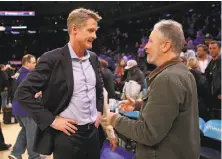 ?? Elsa / Getty Images ?? Left: Warriors head coach Steve Kerr talks with comedian and Knicks fan Jon Stewart after the game.