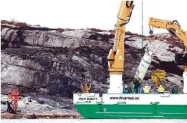  ?? Torstein Boe / AFP / Getty Images ?? A rescue vessel lifts pieces of the helicopter that crashed off Norway’s coast with 13 people who were returning to land from Statoil’s Gullfaks B oil platform. The crash’s cause was unclear, but the company grounded all similar helicopter­s.