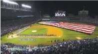  ?? ASSOCIATED PRESS FILE PHOTO ?? A giant U.S. flag is displayed during the national anthem before Game 3 of the Major League Baseball World Series in October.