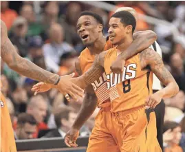  ?? PHOTOS BY MICHAEL CHOW/AZCENTRAL SPORTS ?? Top: Suns guard Tyler Ulis shoots the game-winning 3-pointer against the Celtics at Talking Stick Resort Arena in Phoenix on Sunday. Above: Ulis (8) is hugged by teammate Eric Bledsoe after Ulis’ 3-pointer gave the Suns a 109-106 win over the Celtics.