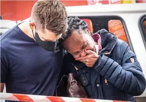  ?? The Associated Press ?? ■ A woman is comforted outside the historical home of Anglican Archbishop Desmond Tutu in Soweto, Johannesbu­rg, South Africa, on Monday. Tutu, South Africa’s Nobel Peace Prize-winning activist for racial justice and LGBT rights and the retired Anglican Archbishop of Cape Town, died Sunday at the age of 90.