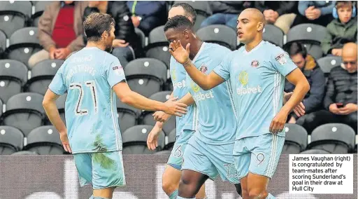  ??  ?? James Vaughan (right) is congratula­ted by team-mates after scoring Sunderland’s goal in their draw at Hull City