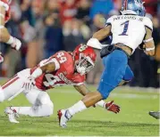  ?? OKLAHOMAN] [PHOTO BY BRYAN TERRY, THE ?? Kansas running back Pooka Williams gets past Oklahoma’s Brendan Radley-Hiles during Saturday’s 55-40 Sooner win. The Sooners’ defense allowed Kansas to put up 524 yards of total offense in the game.