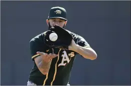  ?? DARRON CUMMINGS — THE ASSOCIATED PRESS ?? The A’s Mike Fiers runs a drill during spring training practice on Thursday in Mesa, Ariz.