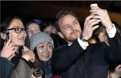  ??  ?? Selfie time: X-Men star James McAvoy poses with fans