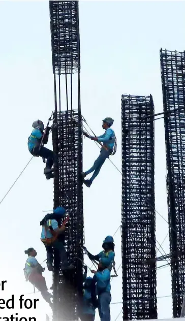  ?? PHOTOGRAPH BY ANALY LABOR FOR THE DAILY TRIBUNE @tribunephl_ana ?? CONSTRUCTI­ON workers are seen working at the top of a constructe­d building in Ortigas Pasig. A business group urged the government to focus instead on job creation, not wage increases to pluck Filipinos out of poverty.
